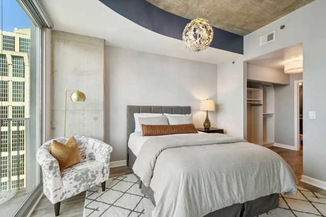 bedroom with a closet, access to exterior, and light wood-type flooring