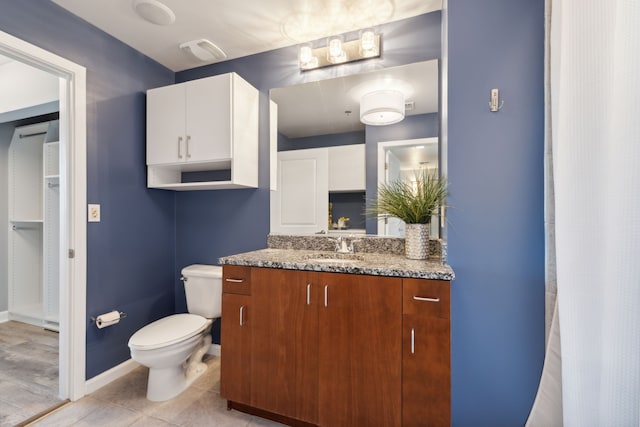 bathroom featuring vanity, wood-type flooring, and toilet