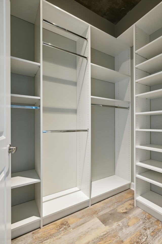 spacious closet featuring hardwood / wood-style floors