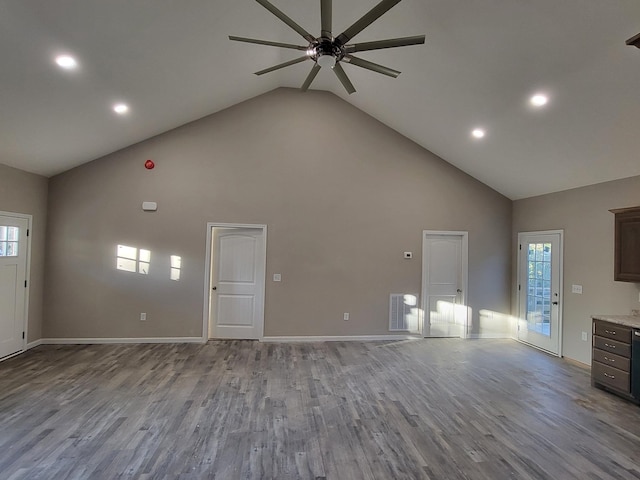 unfurnished living room with ceiling fan, light hardwood / wood-style flooring, and high vaulted ceiling