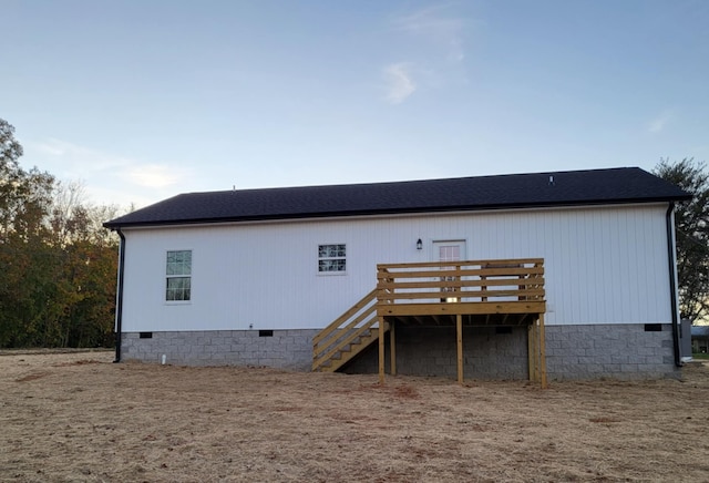 back of house featuring a wooden deck