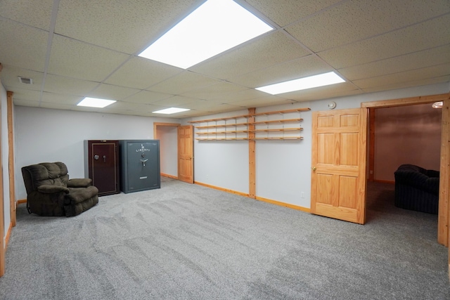 basement featuring a drop ceiling and carpet floors