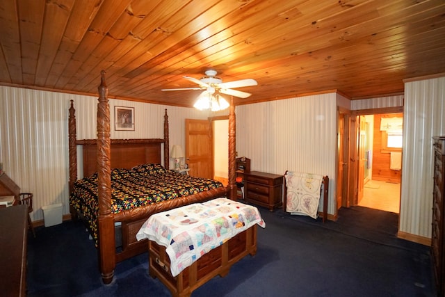 bedroom featuring ceiling fan, ensuite bath, wooden ceiling, and dark colored carpet