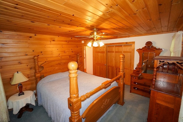 bedroom featuring a closet, wood ceiling, carpet, and ceiling fan