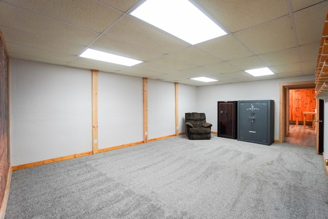 basement with a drop ceiling and carpet floors