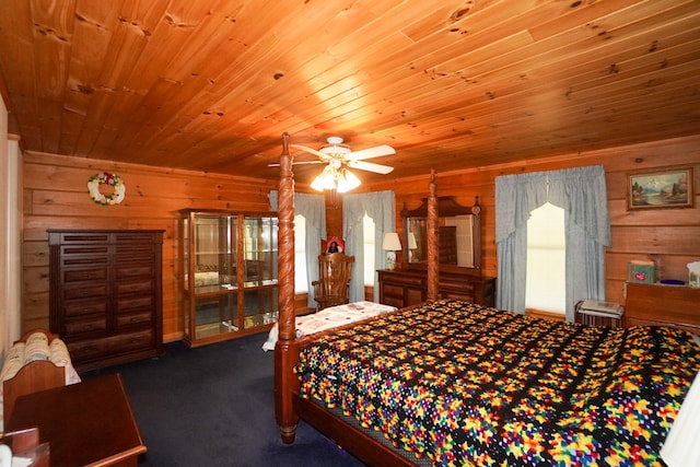 carpeted bedroom featuring ceiling fan, wood walls, and wooden ceiling