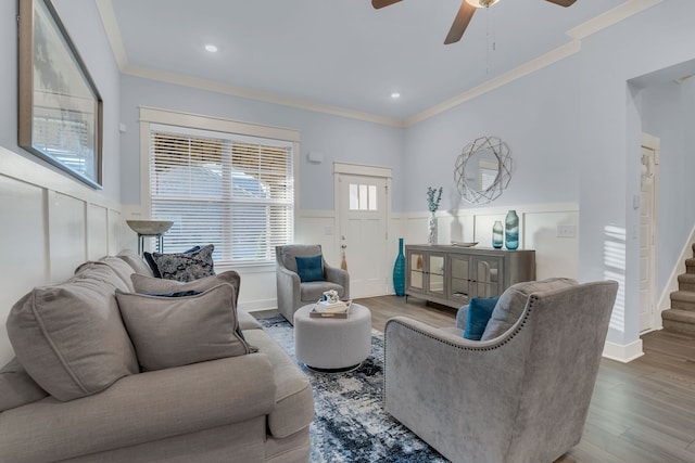 living room with ceiling fan, wood-type flooring, and ornamental molding