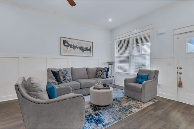 living room with dark hardwood / wood-style floors, ceiling fan, and crown molding