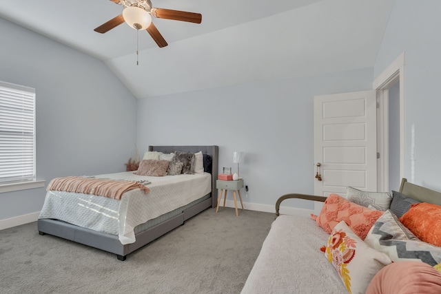 carpeted bedroom with ceiling fan and vaulted ceiling