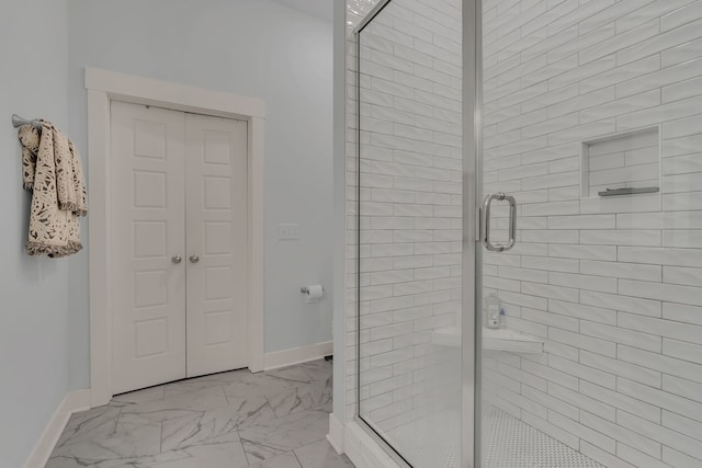 bathroom with a shower with door