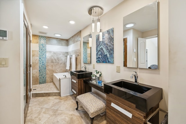 bathroom with vanity and tiled shower