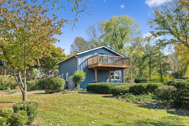 exterior space with a deck and a lawn