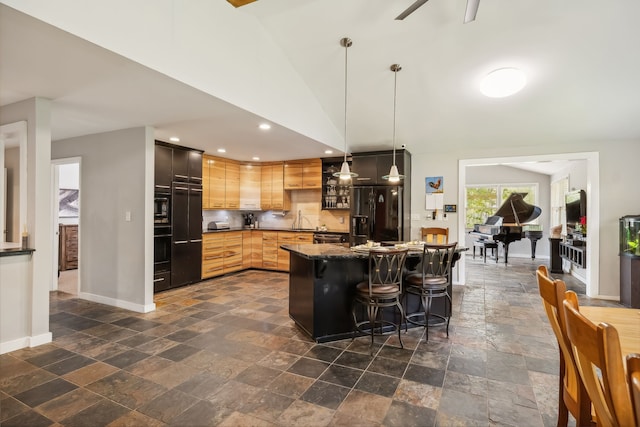 kitchen with a breakfast bar, light brown cabinets, pendant lighting, ceiling fan, and black appliances