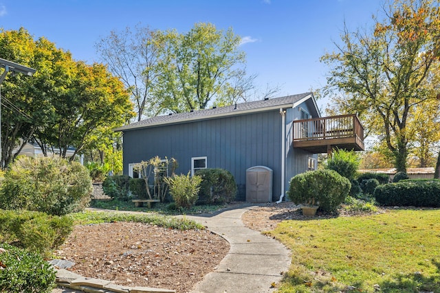 view of home's exterior featuring a lawn and a deck