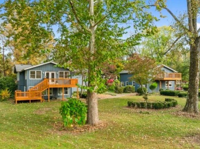 back of house with a lawn and a deck