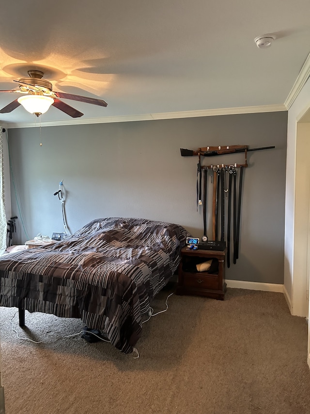 carpeted bedroom featuring ceiling fan and ornamental molding