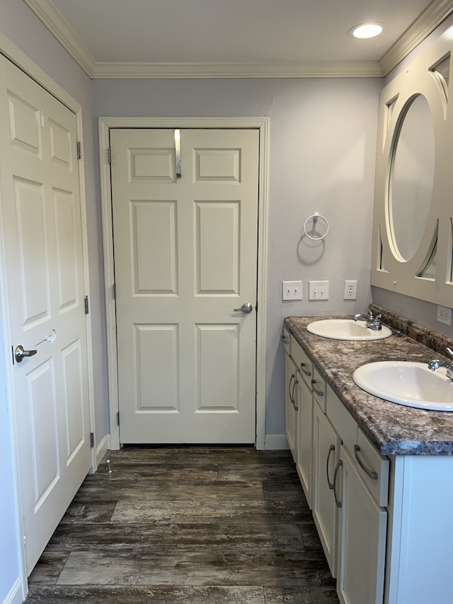 bathroom featuring vanity, crown molding, and wood-type flooring