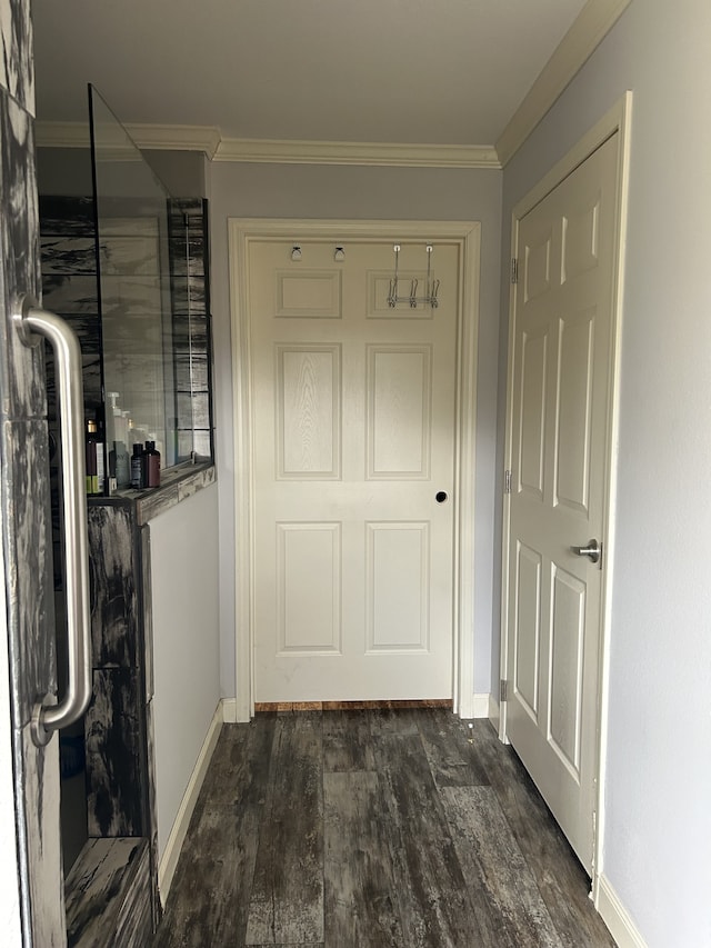 hall featuring ornamental molding and dark hardwood / wood-style flooring