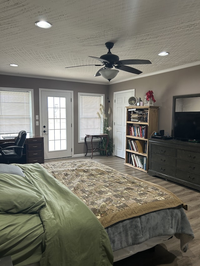 bedroom featuring crown molding, hardwood / wood-style floors, and ceiling fan