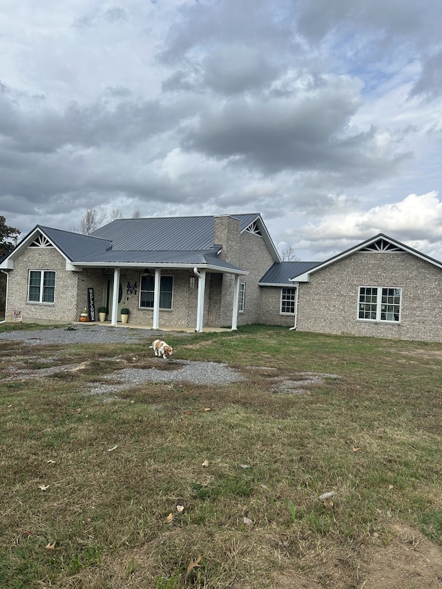 rear view of property with a lawn