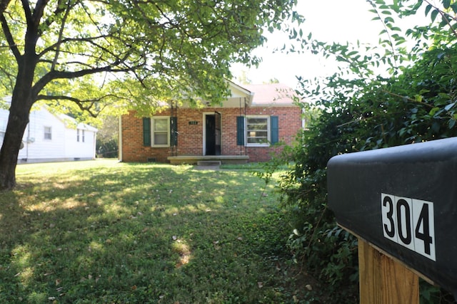 304 Mitchell St, Clarksville, TN 37042 - view of front of house featuring brick siding and a front lawn