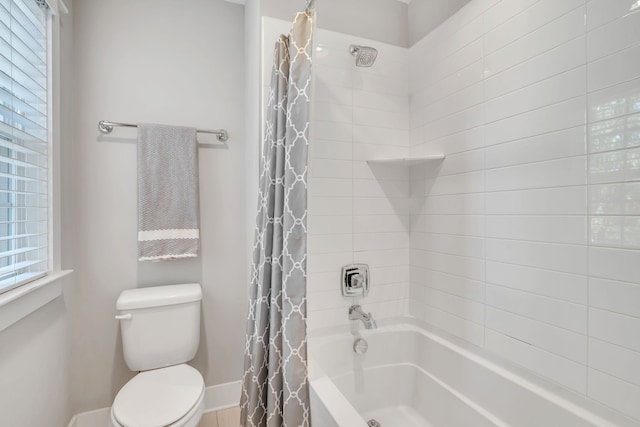 bathroom with shower / bath combination with curtain and toilet