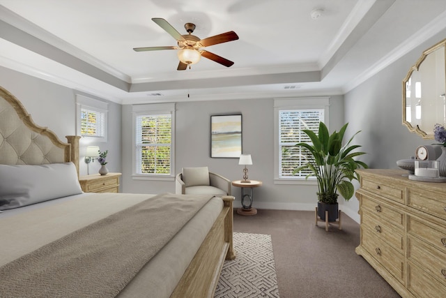 bedroom with carpet, crown molding, a tray ceiling, and ceiling fan