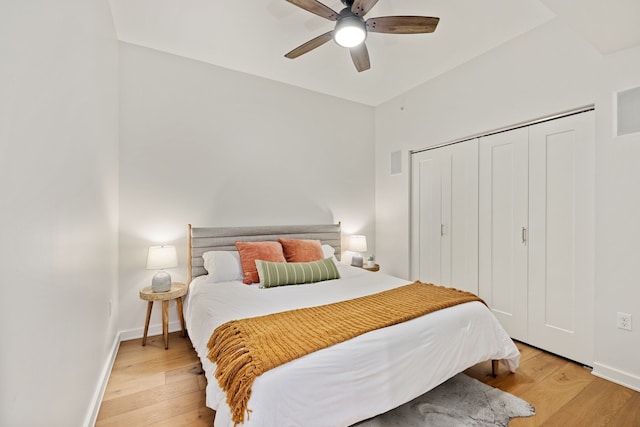 bedroom featuring light hardwood / wood-style flooring, a closet, and ceiling fan