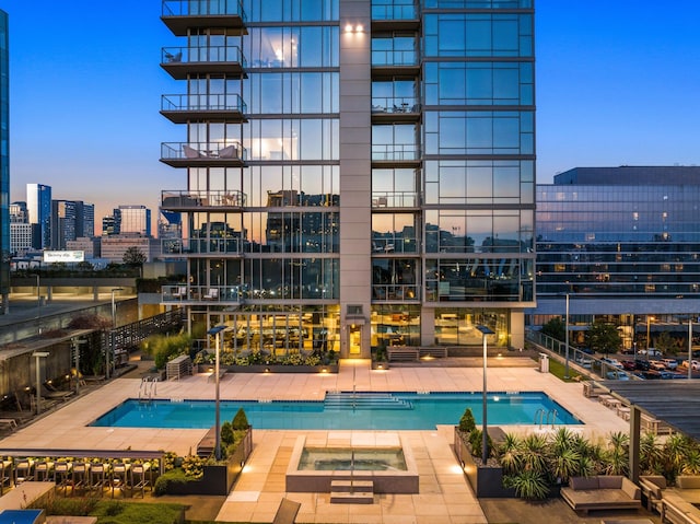 pool at dusk with a patio