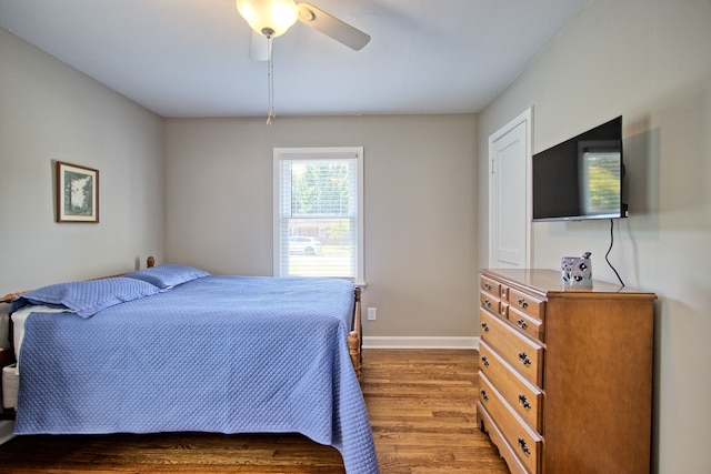 bedroom with dark wood-type flooring and ceiling fan