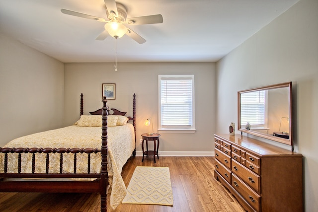 bedroom featuring light hardwood / wood-style floors, multiple windows, and ceiling fan