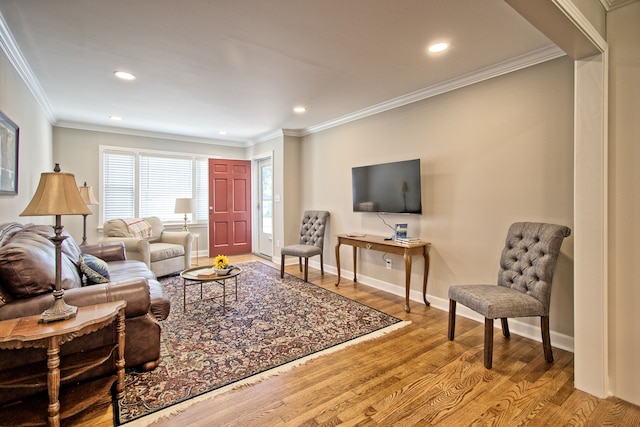 living room with ornamental molding and light wood-type flooring