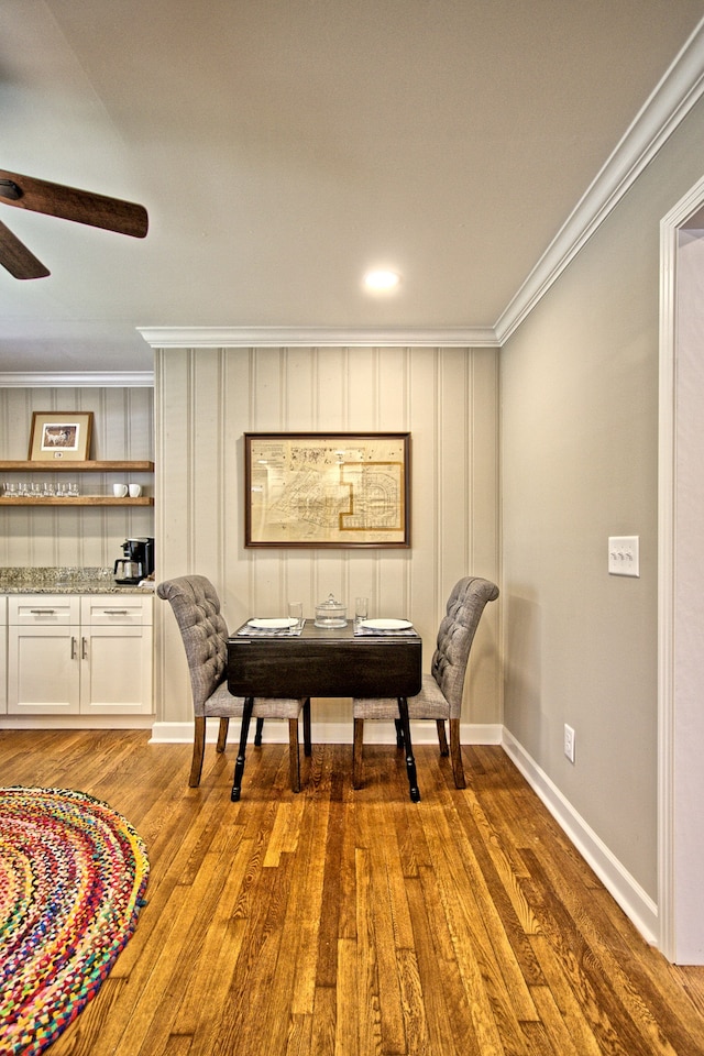 sitting room featuring crown molding, wood-type flooring, and ceiling fan