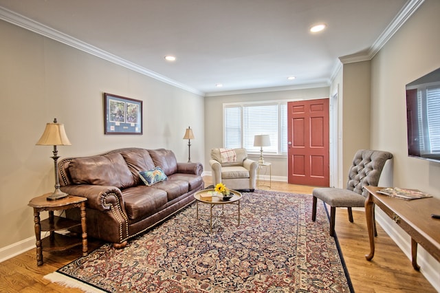 living room with crown molding and light hardwood / wood-style flooring