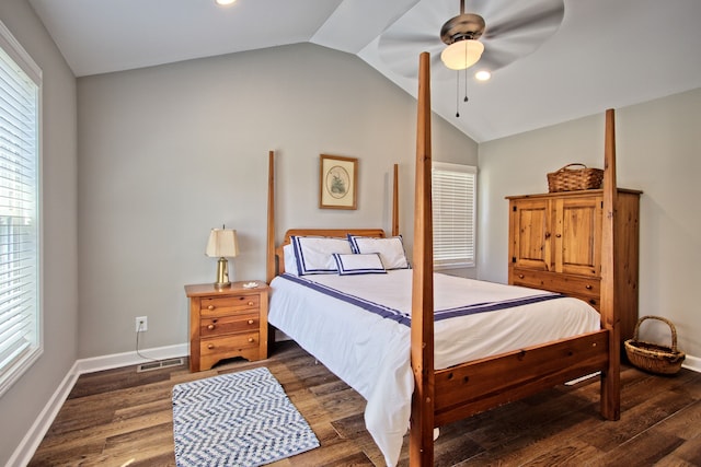 bedroom with dark hardwood / wood-style flooring, vaulted ceiling, and ceiling fan