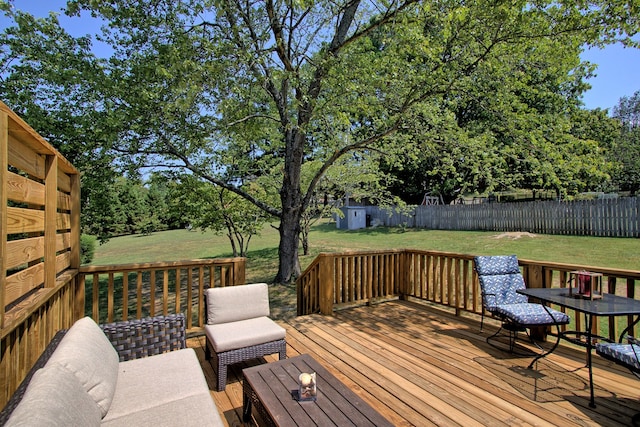 wooden deck featuring a storage shed, a yard, and an outdoor hangout area