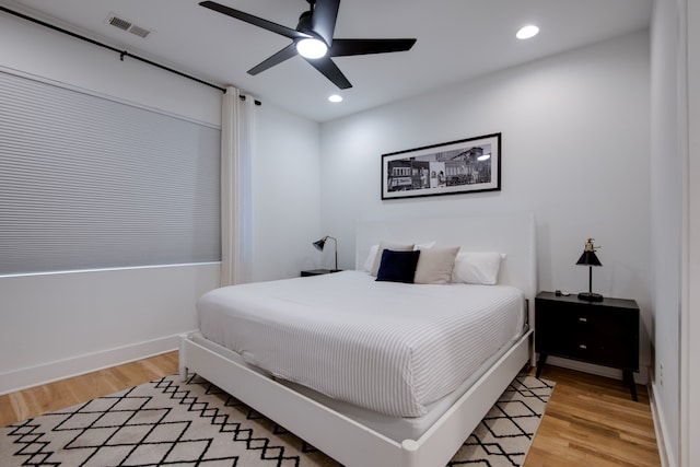 bedroom with light hardwood / wood-style floors and ceiling fan