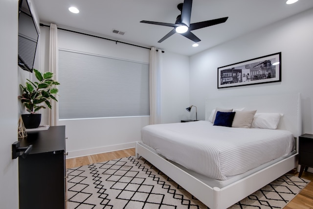 bedroom with wood-type flooring and ceiling fan