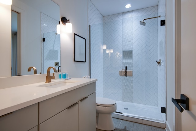 bathroom featuring vanity, toilet, tile patterned floors, and a shower with shower door