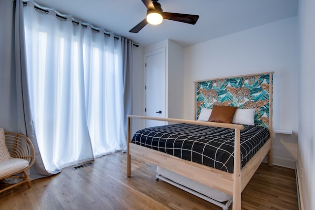 bedroom featuring hardwood / wood-style floors and ceiling fan