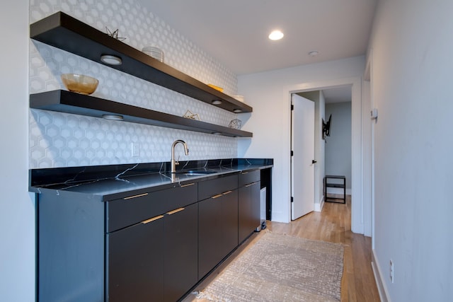 2809 Delaware Ave Unit 202, Nashville, TN 37209 - kitchen with open shelves, dark countertops, tasteful backsplash, and light wood-type flooring