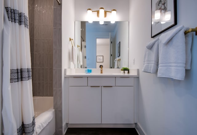 bathroom with shower / bath combination with curtain and vanity