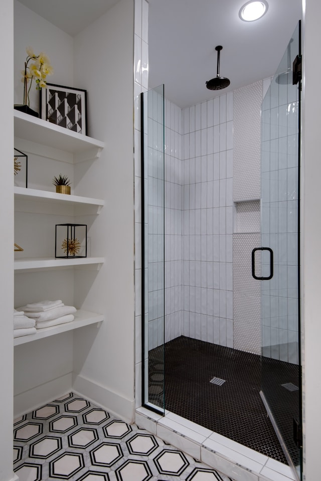 bathroom with tile patterned floors and a shower with shower door