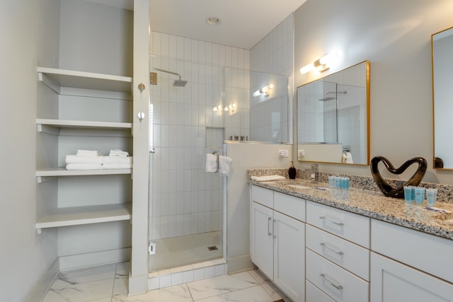 bathroom with vanity and tiled shower