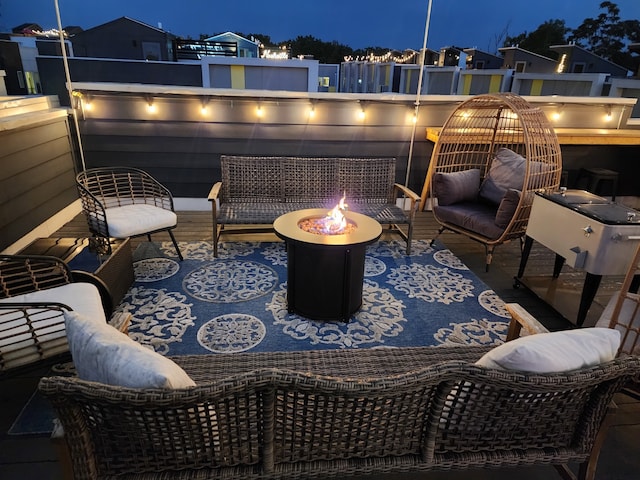 patio at twilight with an outdoor living space with a fire pit