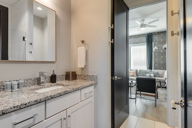 bathroom with vanity, hardwood / wood-style floors, and ceiling fan