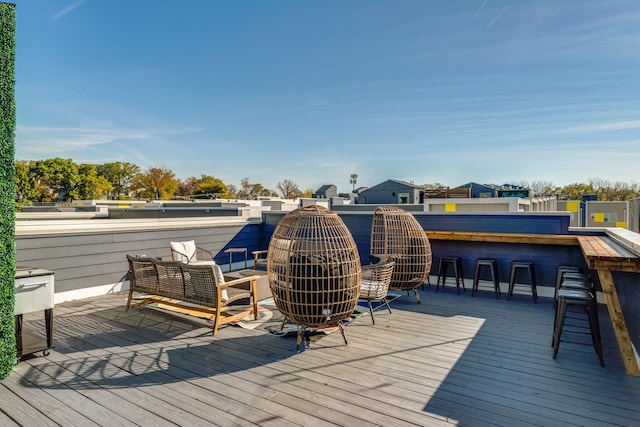 wooden deck featuring exterior bar