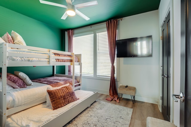 bedroom with ceiling fan and light wood-type flooring