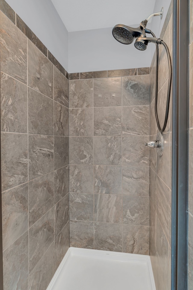 bathroom with a tile shower