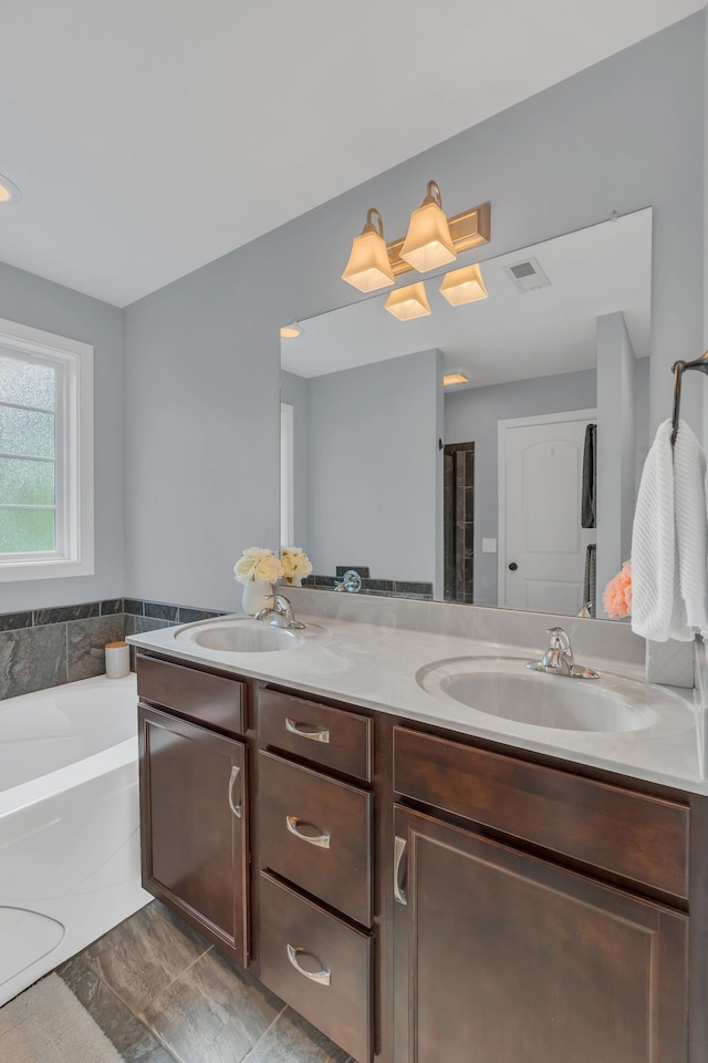 bathroom featuring vanity, hardwood / wood-style flooring, and a bath